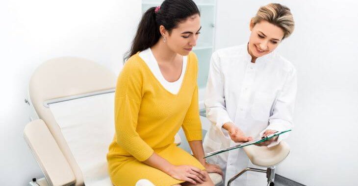 A woman at first pregnancy doctor appointment at OB/GYN.