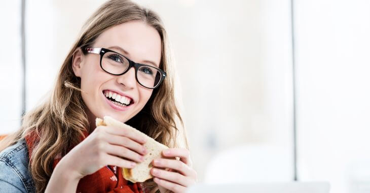 Young woman eating a sandwich