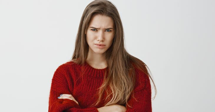 Upset young woman with frown lines