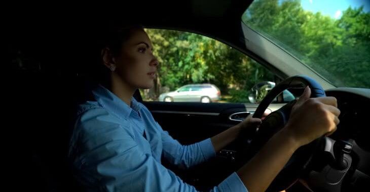 woman looking for a parking space near a dental office