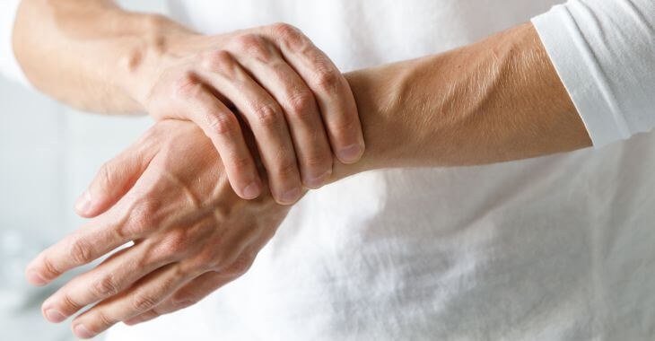 Hands of a person suffering from arthritis pain.