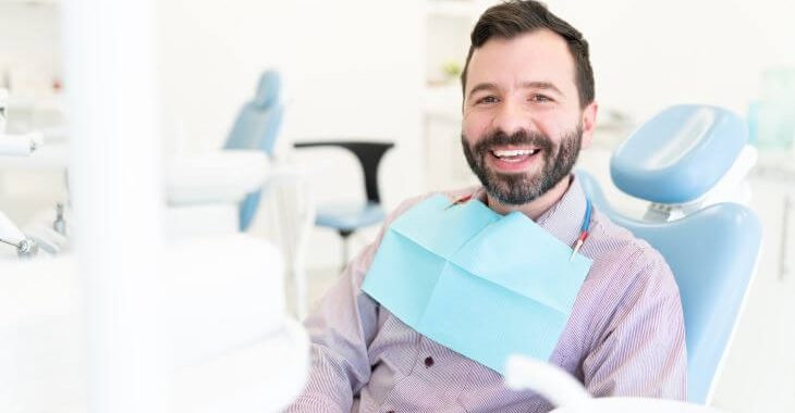 Relaxed happy man in a dental chair after having root canal completed