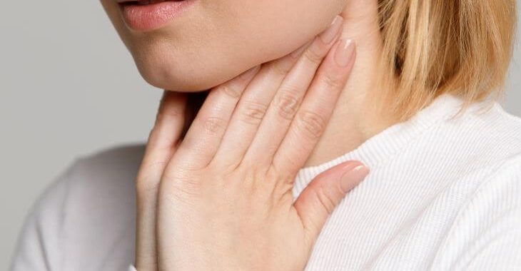 Woman touching her swollen preauricular lymph nodes.