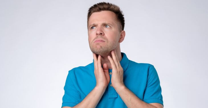 Concerned man touching his neck on sides checking his swollen preauricular lymph nodes.