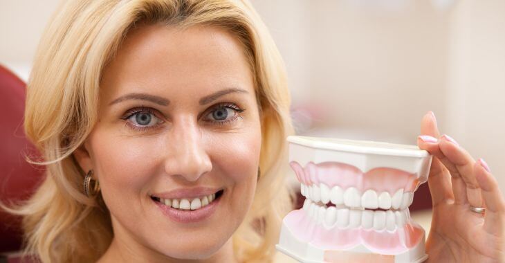 Woman with a dental model