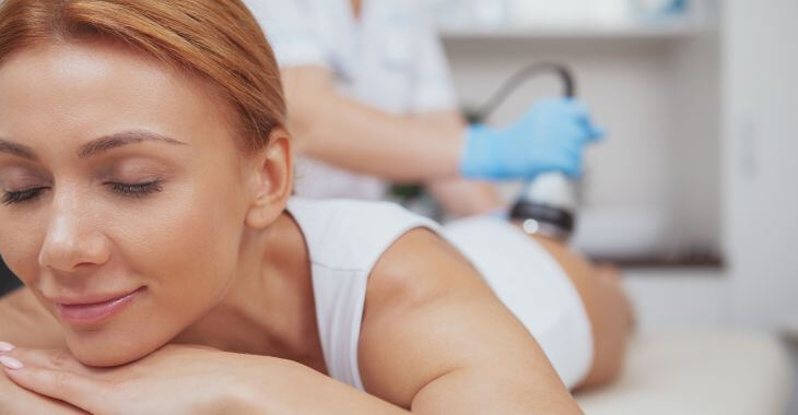 Relaxed woman undergoing RF body tightening treatment.