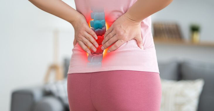 Woman suffering from lumbar pain due to spinal stenosis.