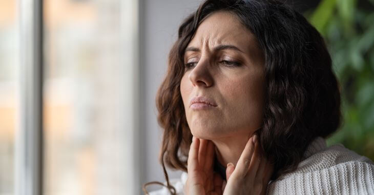A woman suffering from sore throat.