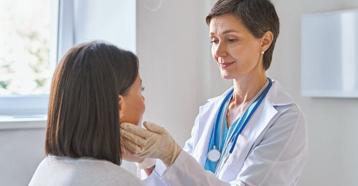 A doctor examining female patient.