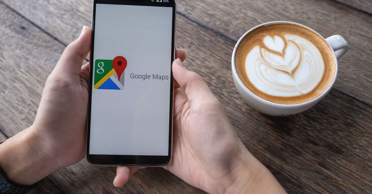 A person having coffee and looking for local services using google maps.