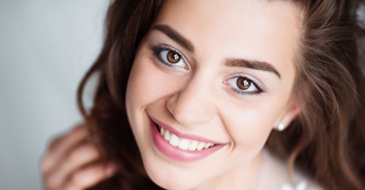 Face of a cheerful young woman with perfect facial skin.