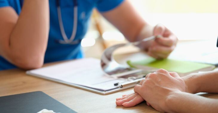 Doctor discussing lab test results with patient.