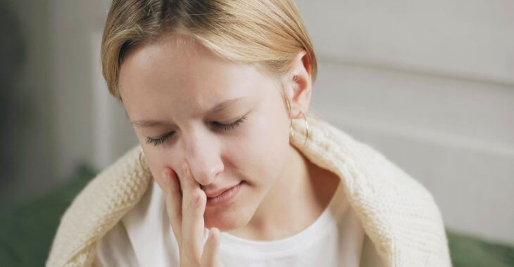 Woman performing deviated septum self test.