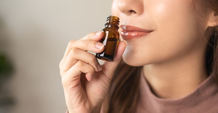 Woman smelling essential oil.