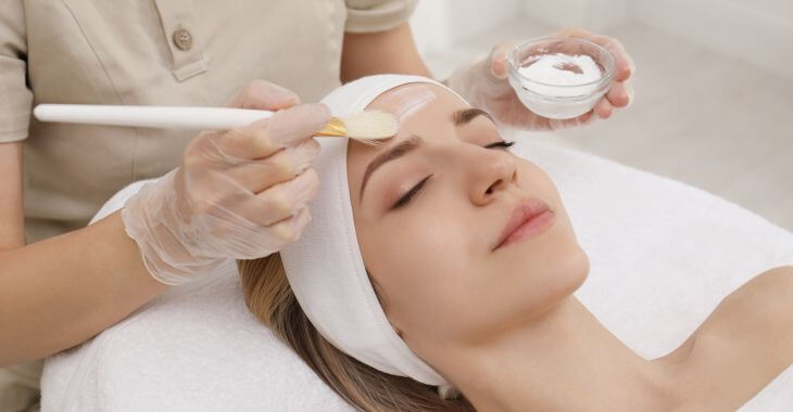 Woman during chemical peel cosmetic procedure.