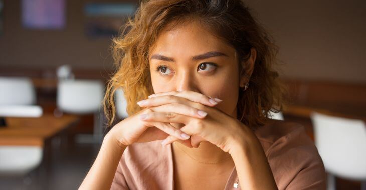 Upset woman sitting in an empty classroom.