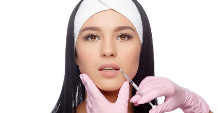 Woman getting lip filler injection