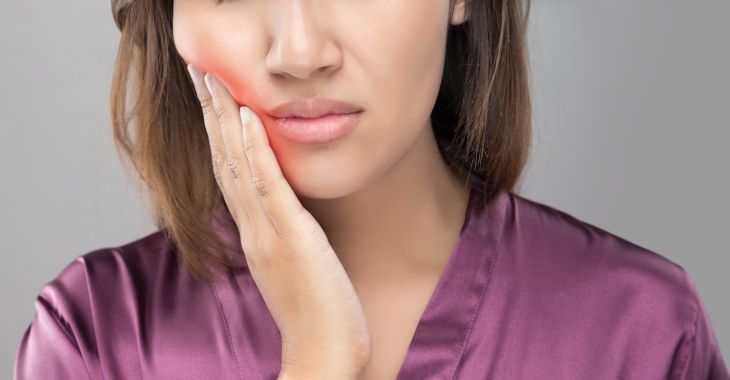 woman suffering from jaw pain