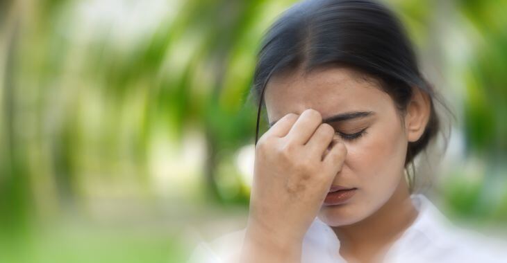 Woman feeling dizzy due to sinus pressure