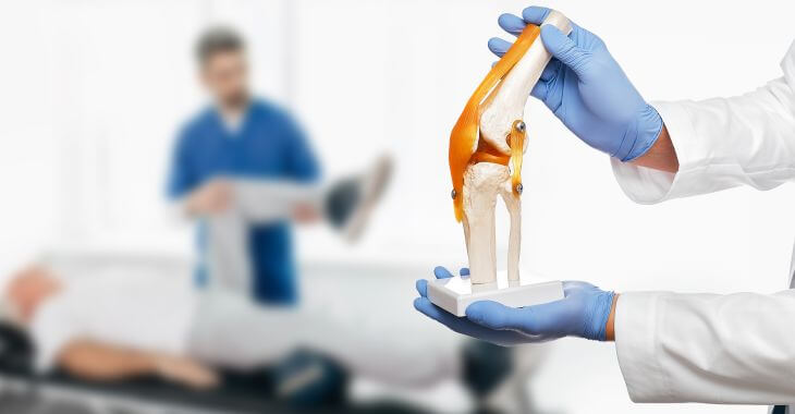 An orthopeadic doctor examining man's knee and a surgeon holding a knee joint model