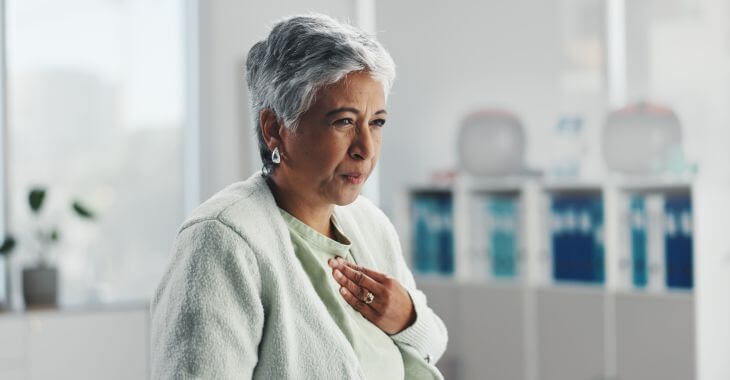 A senior lady feeling heartburn caused by acid reflux